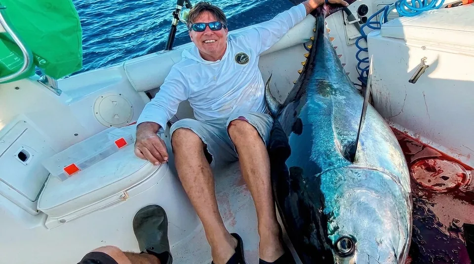 Angler with a giant bluefin tuna on the deck off Baja
